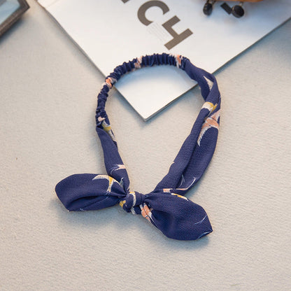 Big bow tie bunny ears headband in a playful design.
