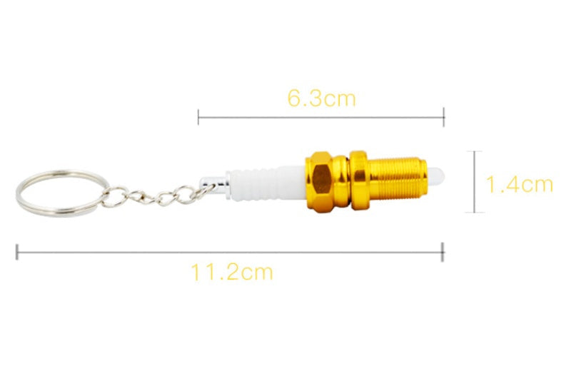 LED light spark plug keychain with compact metallic design and attached key ring