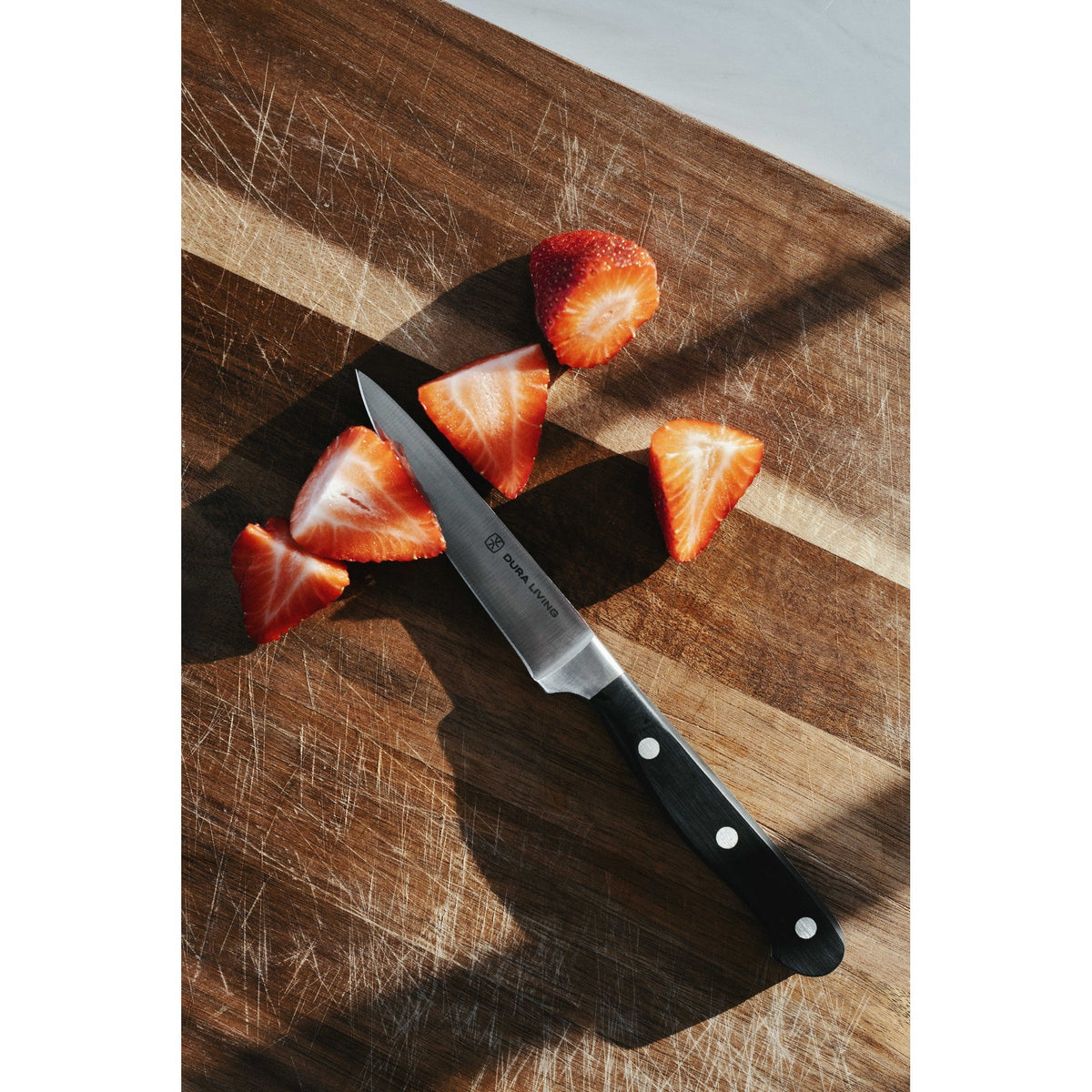 Dura Living Superior 4-piece black kitchen knife set with stainless steel blades and ergonomic handles displayed together.