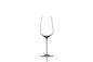 Ritual white wine in a clear glass bottle with a white label, served in a wine glass, on a wooden table background.