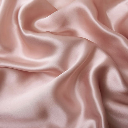 Natural silk pillowcase in smooth pure silk fabric, close-up view of soft bedding texture