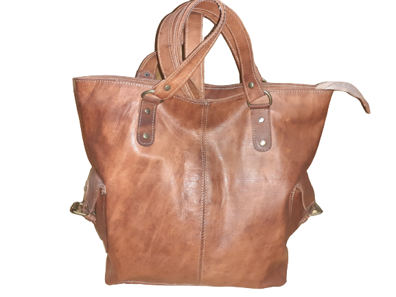 Handmade women's shoulder bag with a strap, featuring a textured leather surface and stylish design.