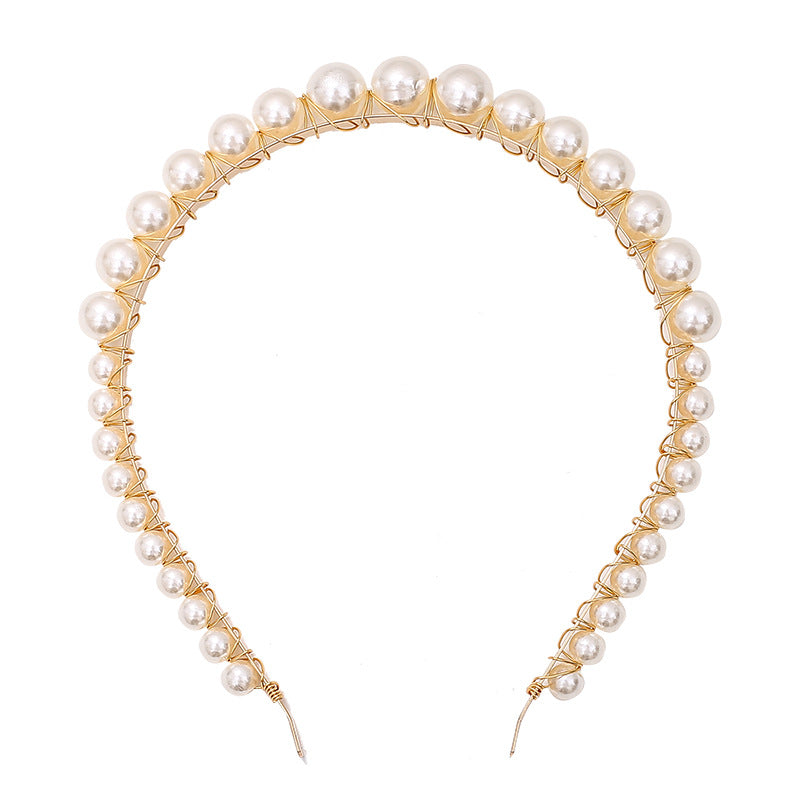 Thin pearl headband with delicate pearl accents on a simple band