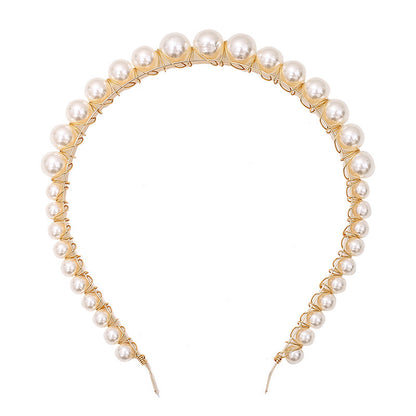 Thin pearl headband with delicate pearl accents on a simple band