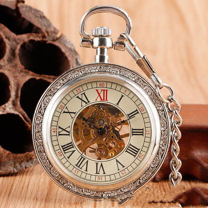 Carved mechanical pocket watch with intricate engraved design and visible classic watch face