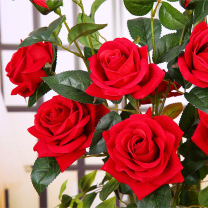 Artificial rose flower with realistic petals and green leaves