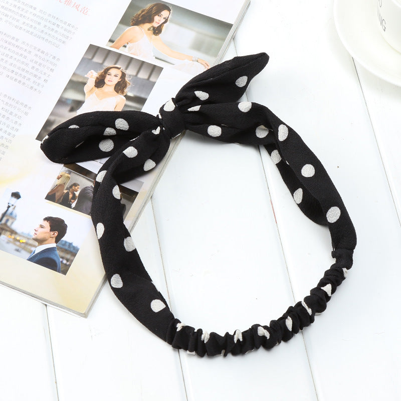 Big bow tie bunny ears headband with playful rabbit ear design, close-up product view