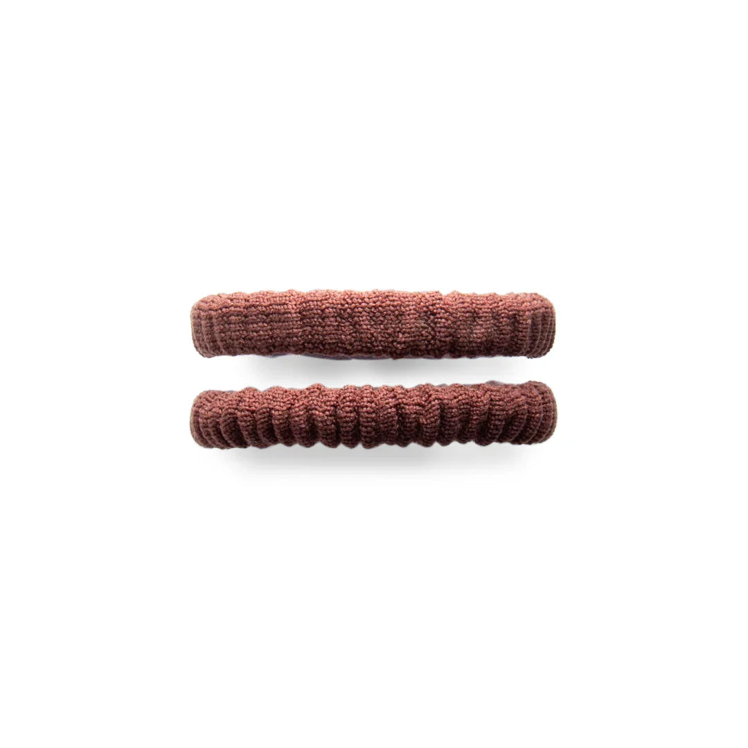 Brown mini scrunchies for ponytails, soft fabric hair accessories by Pasteur Pharmacy, shown in a close-up image.