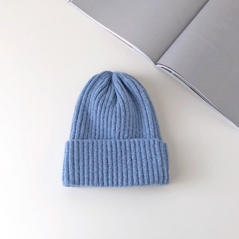 Warm knitted hat in a cozy textured design, shown in a neutral color