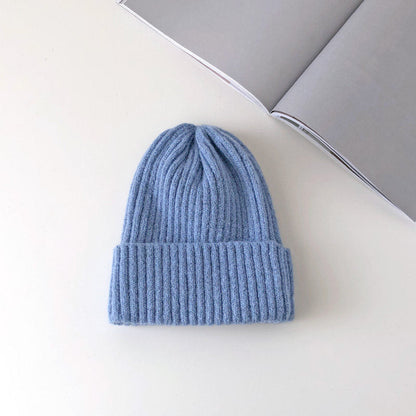 Warm knitted hat in a cozy textured design, shown in a neutral color