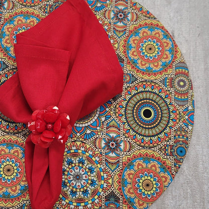 Set of four Maison Charlo round MDF wood placemats with colorful mandala Psychedelic designs, 14-inch diameter.