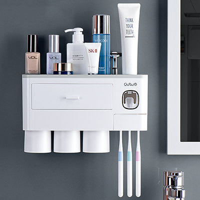 Non-marking hanging magnetic toothbrush holder with single drawer, toothpaste squeezer, and toiletry storage rack