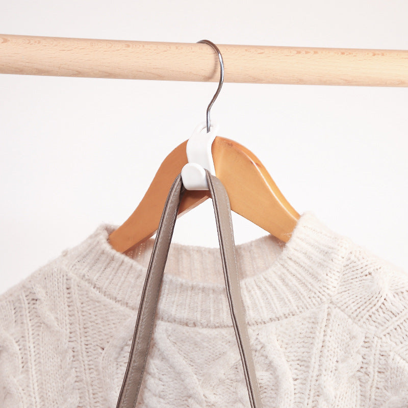 Plastic closet stack hanger rack with multi-function wardrobe hanger hooks for space-saving bedroom storage.