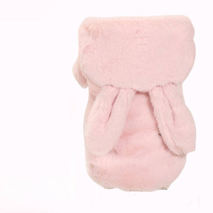 Small dog wearing an autumn and winter four-legged padded coat in a warm, cozy design