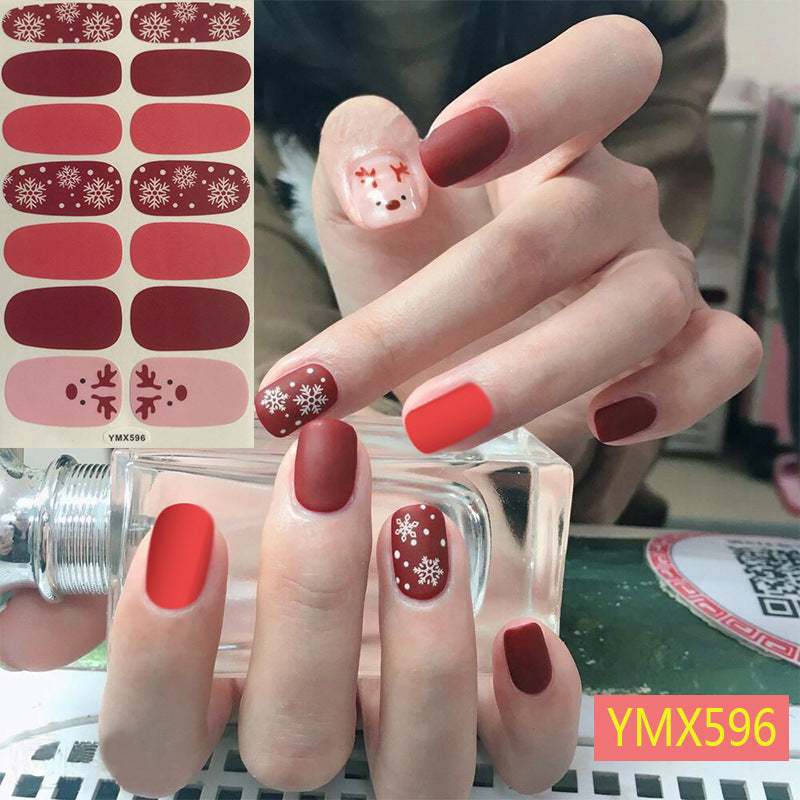 Christmas nail stickers in festive holiday designs, sheet displayed on a white background