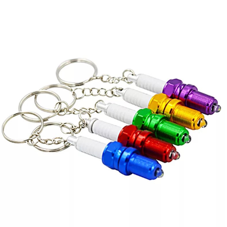 LED light spark plug keychain with compact metallic design and attached key ring
