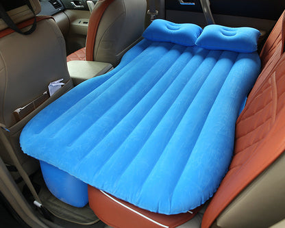 Inflatable car bed with cushioned surface and raised sides for comfortable travel sleeping setup