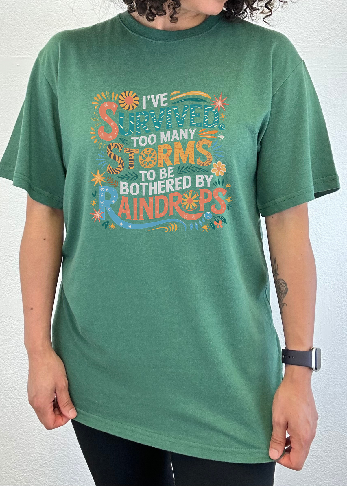 Unisex bamboo and cotton graphic T-shirt by Spun Bamboo with "I've Survived Too Many Storms" print, men's printed T-shirt design.
