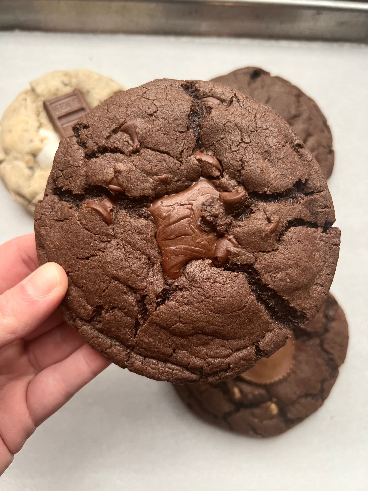 Death by Nutella cookies from Let's Get Baked Artisan Desserts with rich chocolate and Nutella filling, displayed on a plate.