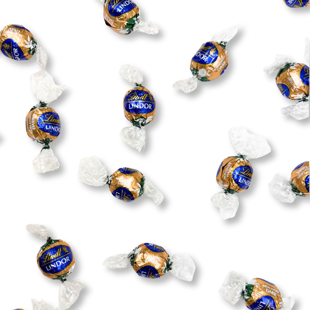 Assorted Lindt LINDOR non-dairy oatmilk dark chocolate truffles in a bulk candy bag, showcasing smooth chocolate coating and creamy filling.