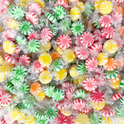 Assorted hard candies in bright wrappers from Candy In Bulk, displayed in a large bulk value bag.