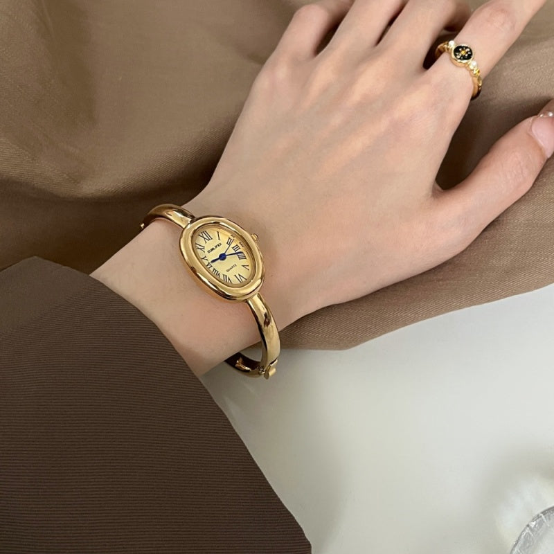 Women's oval Roman-numeral bracelet watch with elegant metal band and classic dial