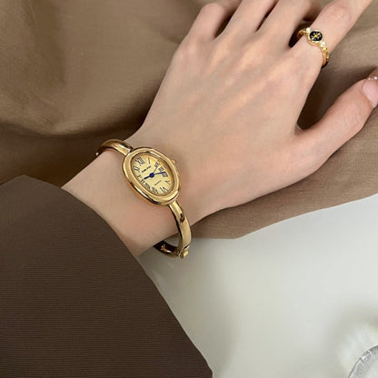 Women's oval Roman-numeral bracelet watch with elegant metal band and classic dial