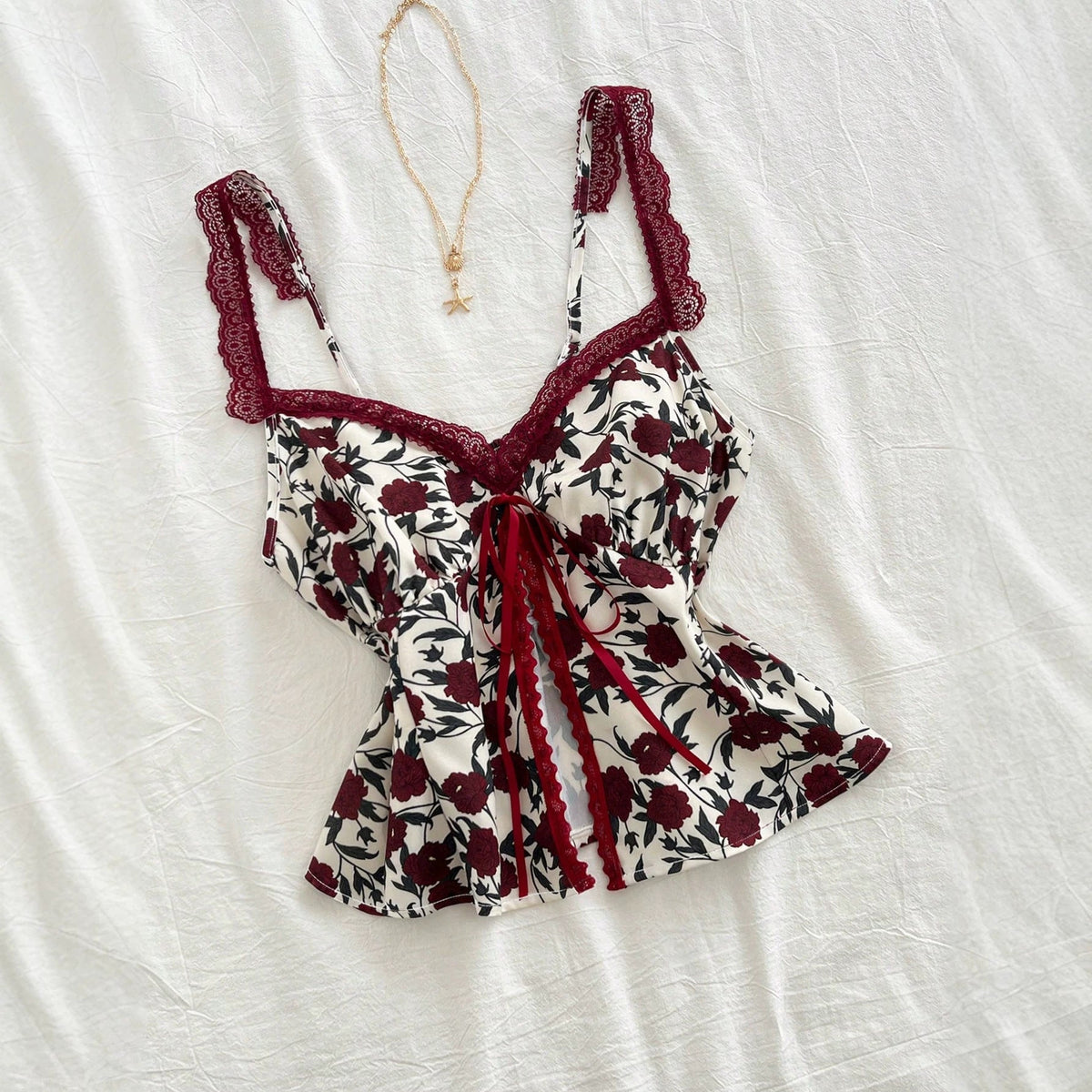 Lace-trimmed camisole with floral bow detail, fashionable versatile women’s top