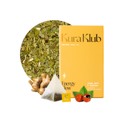 Kura Klub Yerba Mate and Guarana tea in a clear glass cup, showing the brewed herbal tea with fresh leaves and vibrant color.