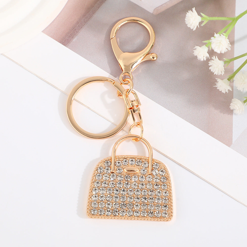 Minimalist diamond-studded handbag charm keychain in a creative design