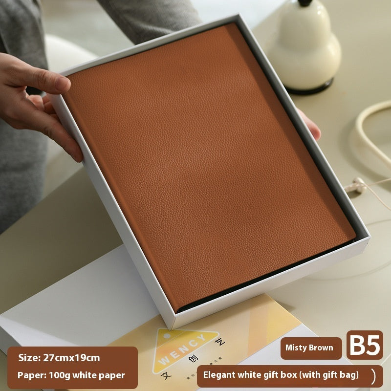 Litchi pattern soft leather covered notebook with textured brown cover and rounded edges