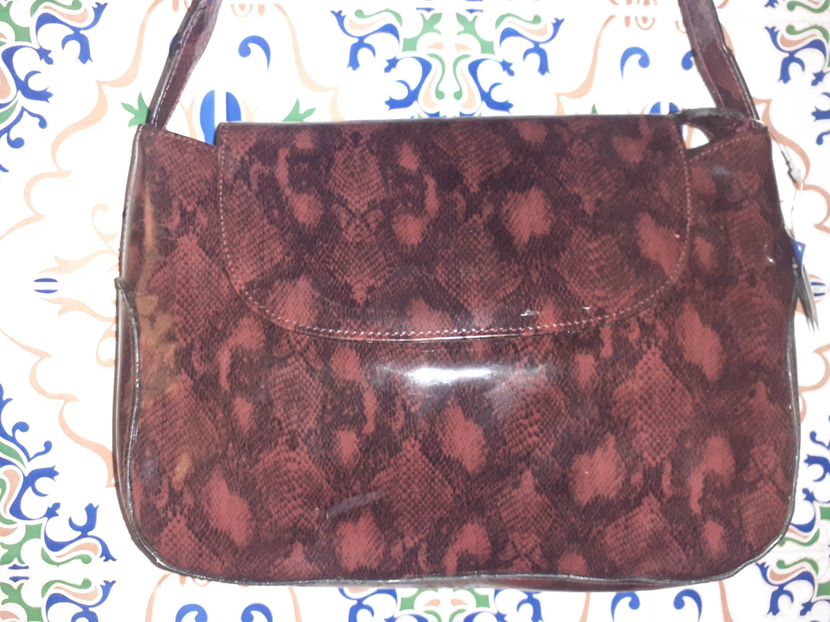 Handmade women's handbag with handles, featuring a stylish and functional design perfect for everyday use.