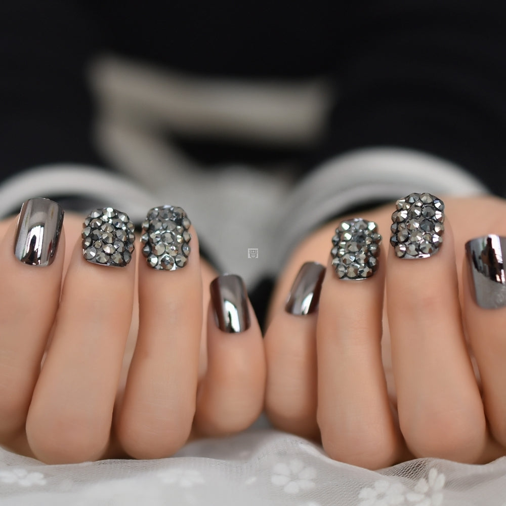 Metal false nails for women, close-up of sleek metallic artificial nail tips