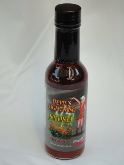 Cinderosa Ranch Devil's Lightning Bhut Jolokia ghost pepper hot sauce bottle with fiery red and orange label and cap.