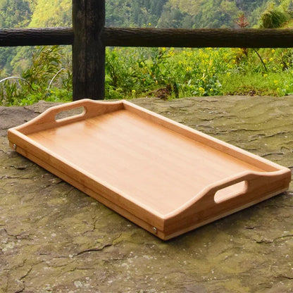 Bamboo folding breakfast tray with adjustable feet and handles, ideal for serving breakfast in bed or tabletop use