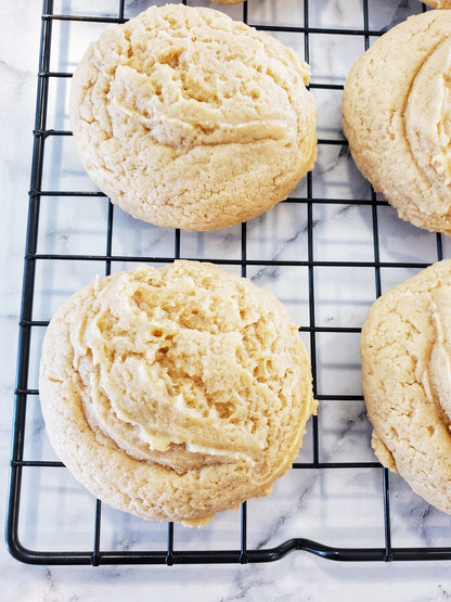 Let's Get Baked Artisan Desserts peanut butter cookie dozen, fresh-baked cookies with golden edges and soft centers on a plate.