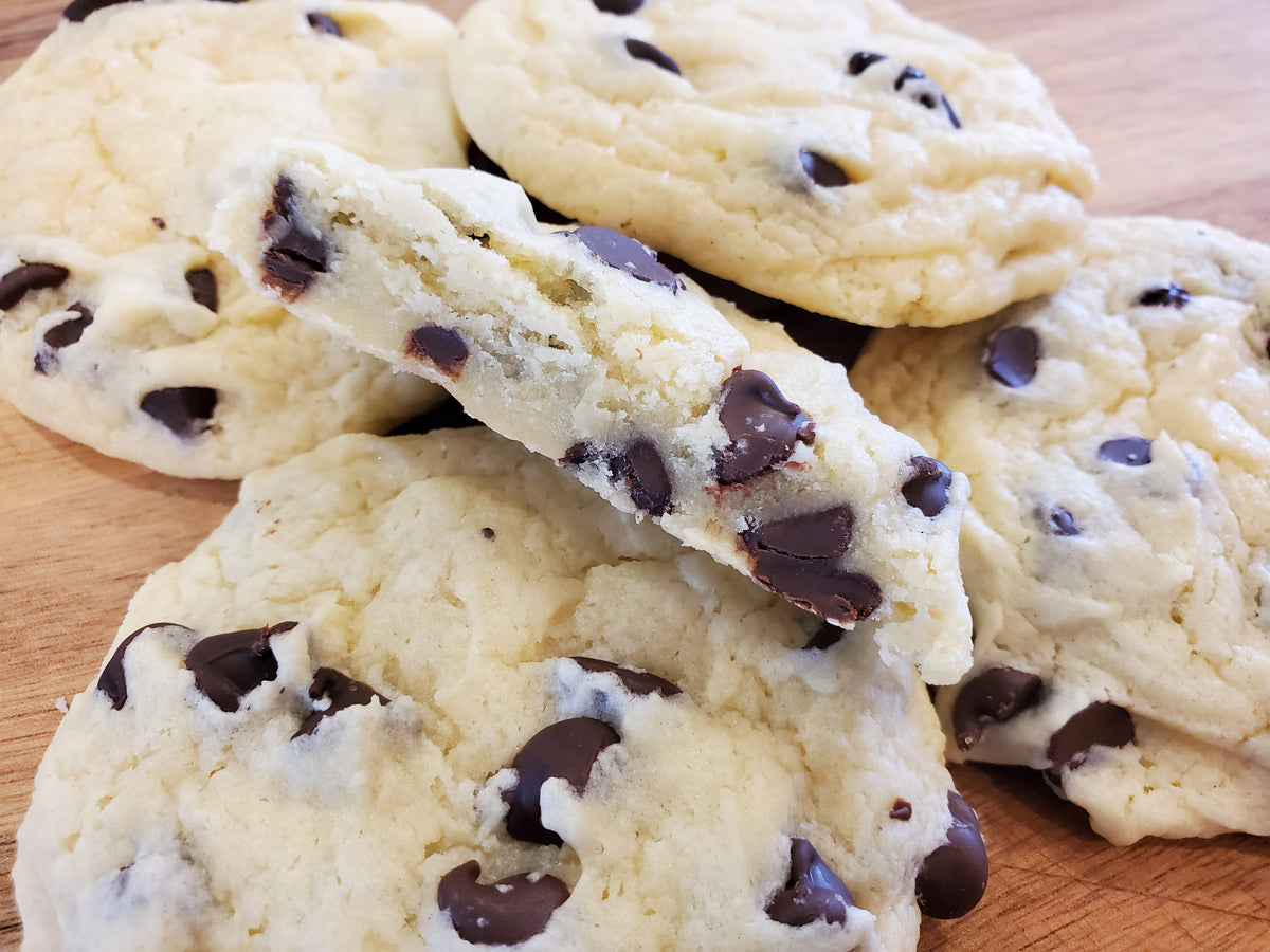 Assorted chocolate chip cookies from Let's Get Baked Artisan Desserts in a dozen, showing golden-brown cookies with chocolate chips.
