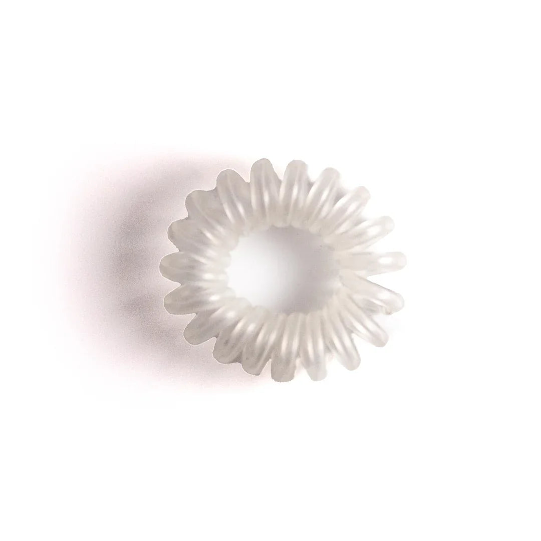 Smoothies Glide Pony Coils ponytail holders by Pasteur Pharmacy, showcasing shiny, colorful hair accessories in a close-up image.