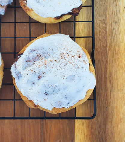 Let's Get Baked Artisan Desserts cinnamon roll cookies with swirled cinnamon filling and golden-brown exterior.