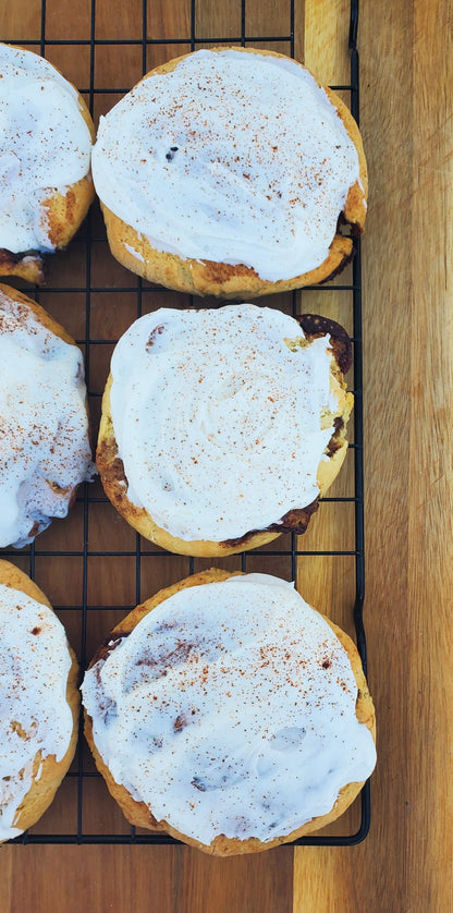 Let's Get Baked Artisan Desserts cinnamon roll cookies with swirled cinnamon filling and golden-brown baked exterior.