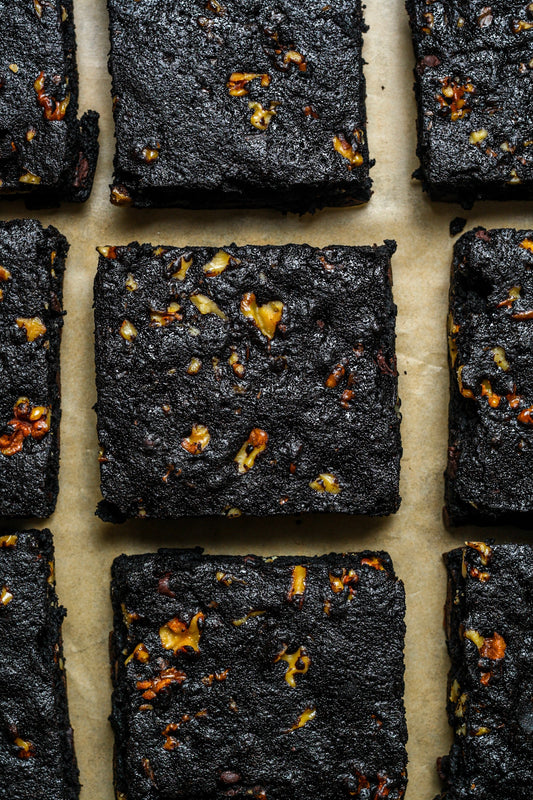 Chocolate walnut protein brownies by Sweet Addison's, featuring rich chocolate and walnut pieces in a close-up shot.