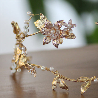 Asymmetric handmade bridal head jewelry with a sculpted design, shown on a white background