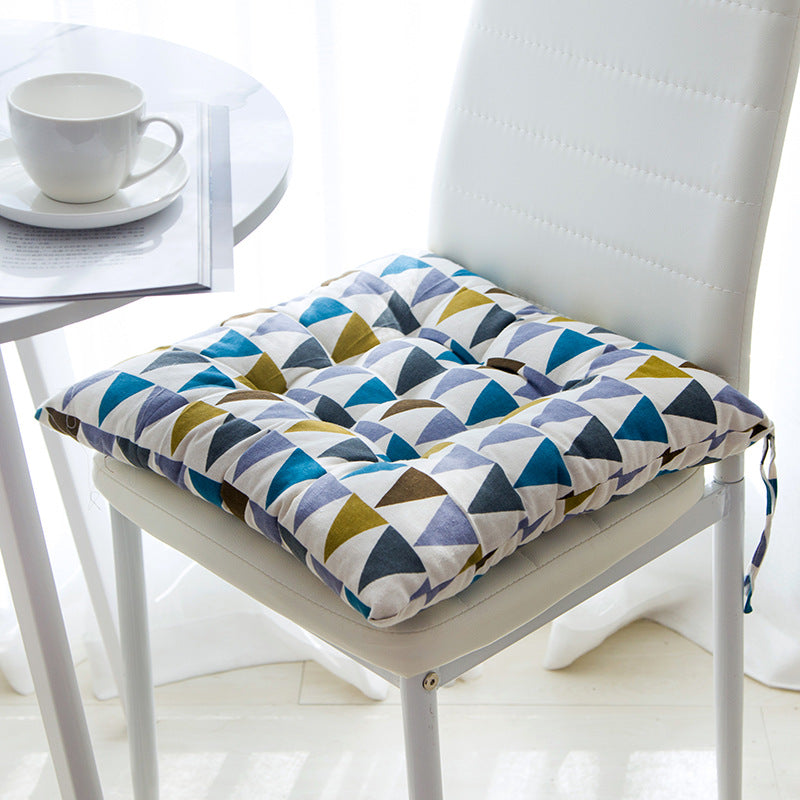 Summer chair cushion in a light, textured fabric for comfortable outdoor seating