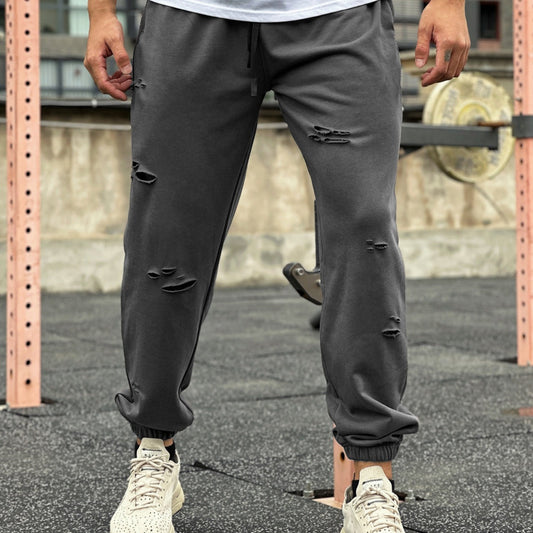 Fitness ripped sweat-wicking jogger pants in black with tapered leg and elastic waistband