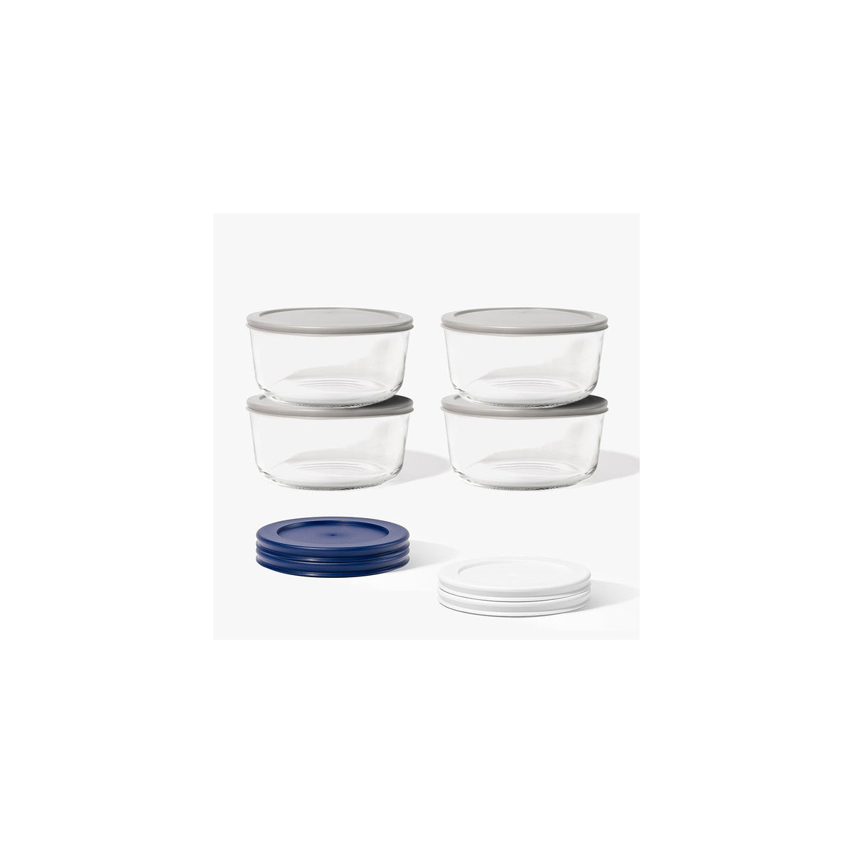 Eight round glass storage containers with blue lids, 6.55 cups capacity, part of Dura Living glassware set.