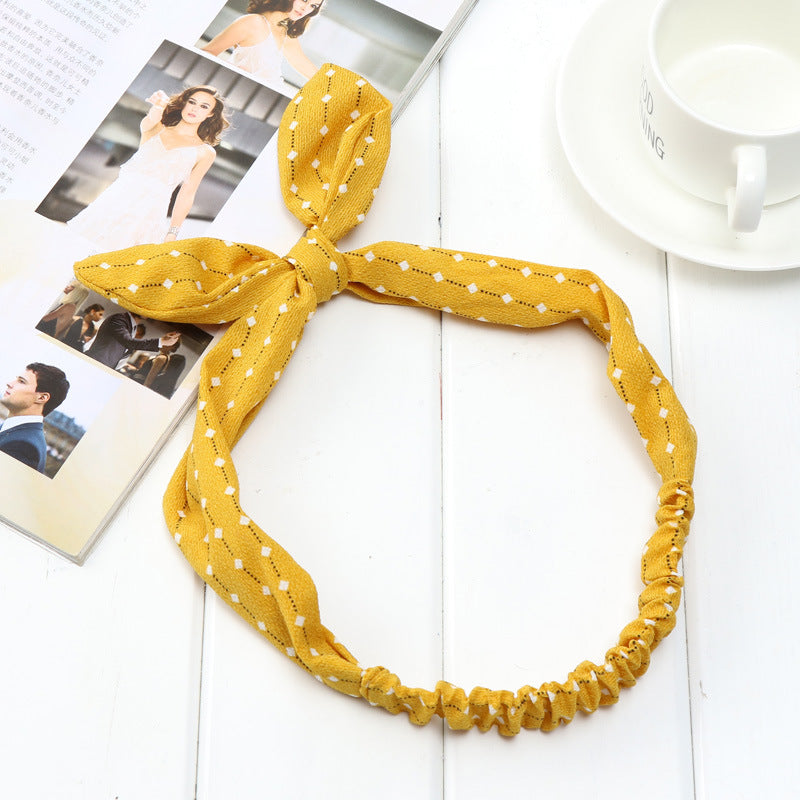 Big bow tie bunny ears headband in a playful design, shown against a clean background