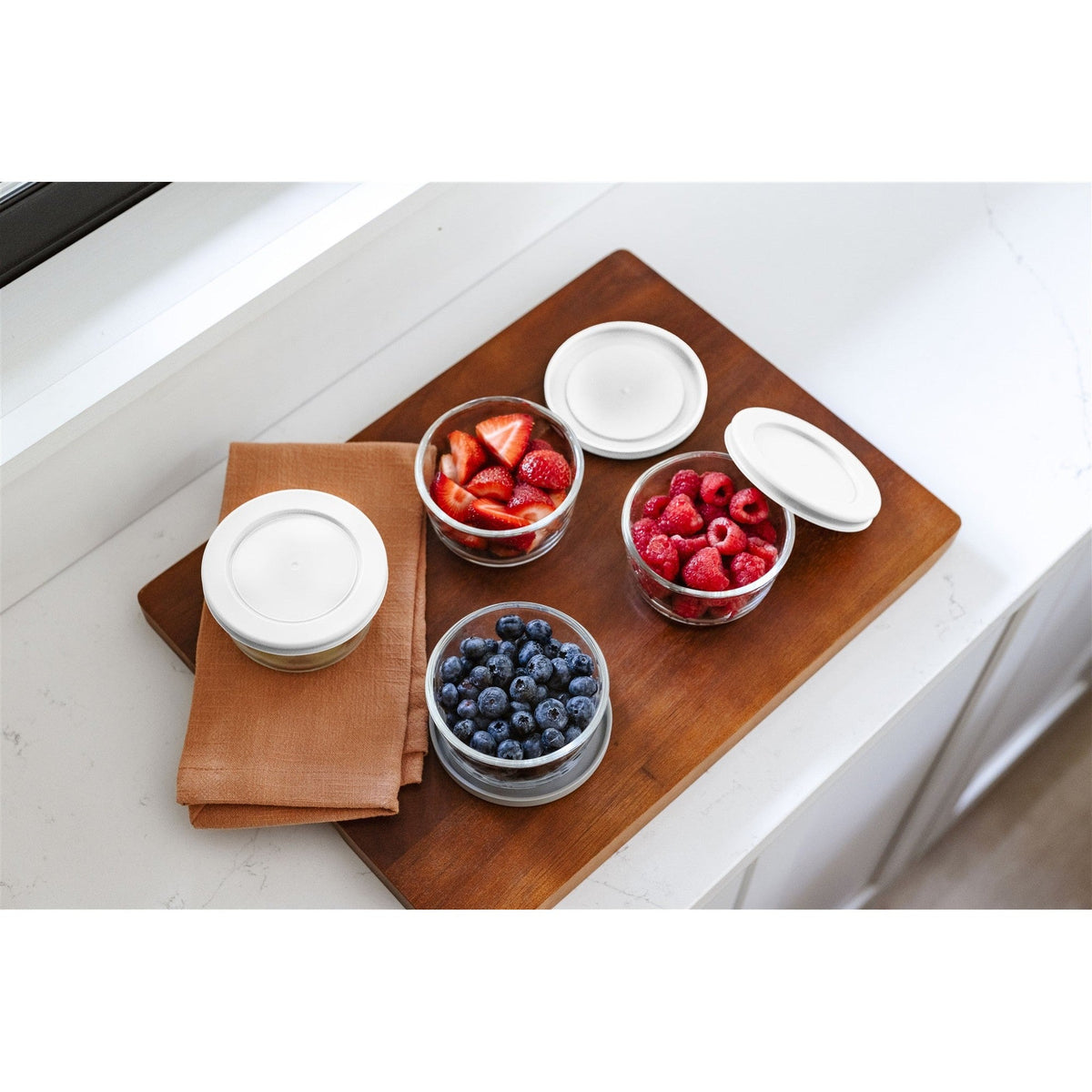 Set of 16 round glass storage containers with white lids, 1 cup (8 oz) capacity, by Dura Living, ideal for kitchen organization.