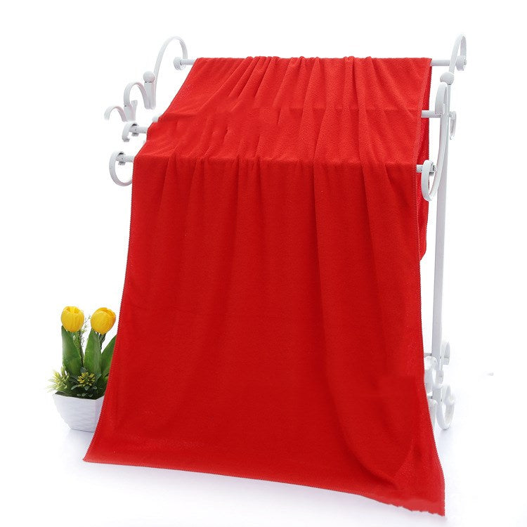 Absorbent microfiber bath towels in soft, textured fabric, folded and displayed neatly