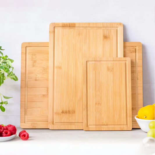 Set of three bamboo cutting boards from Dura Living, featuring varying sizes and natural wood grain for kitchen use.