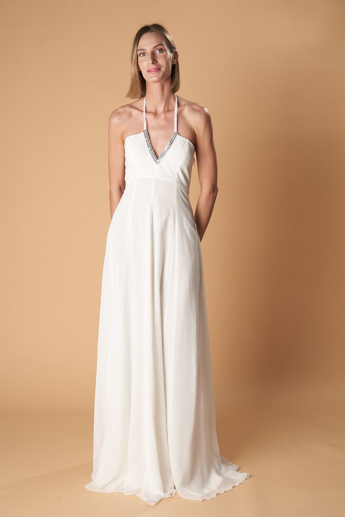 Ceylan Bcn Monaco long dress in flowing fabric with elegant design, detailed neckline, and full-length silhouette.